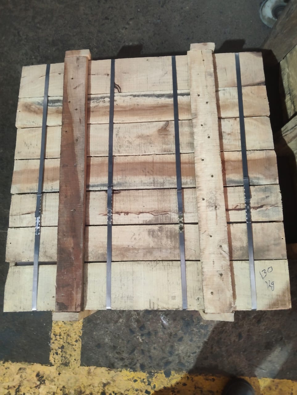 Timber package reinforced with metal straps
