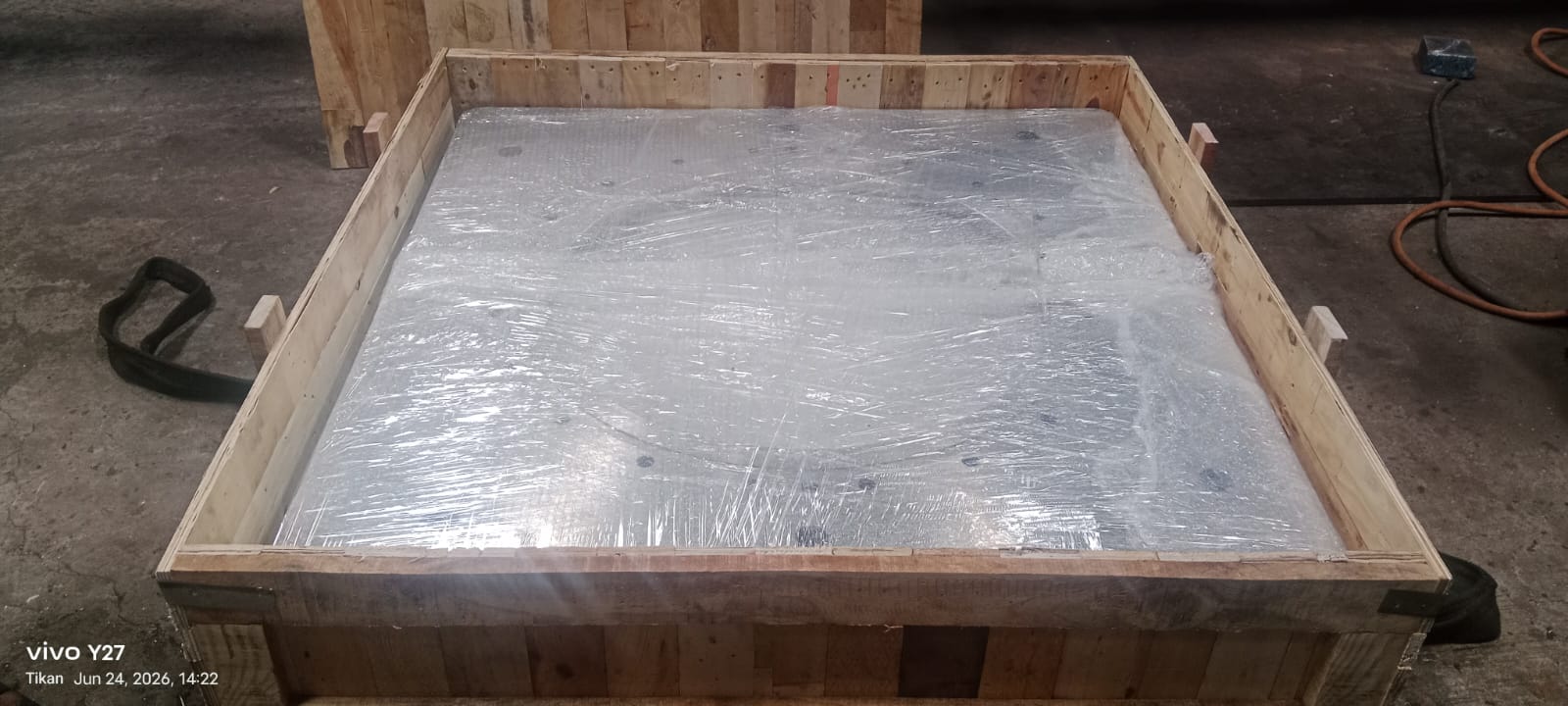 Large industrial component wrapped inside an open timber crate