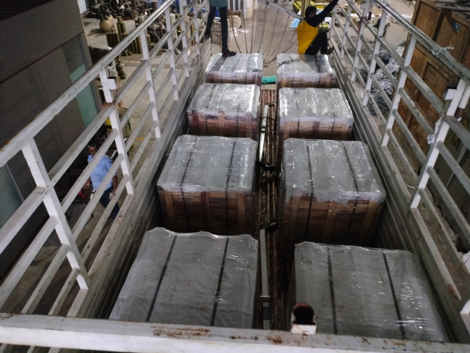 Multiple protected export crates loaded onto a transport vehicle