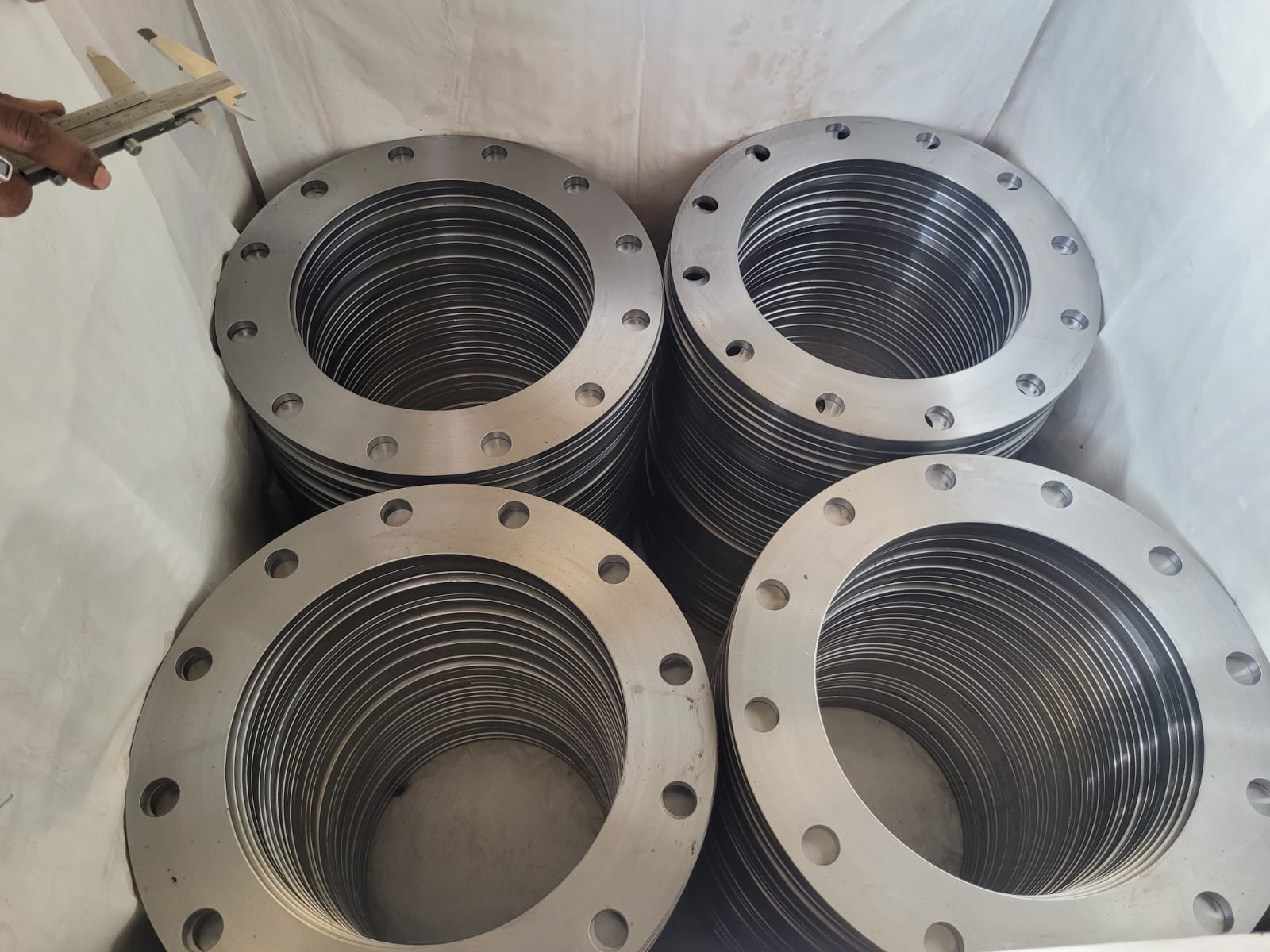 Stacks of finished machined flanges arranged for inspection
