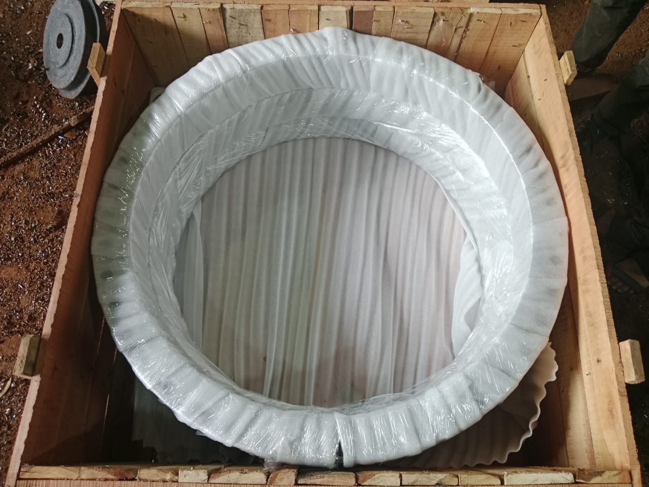 Large circular component protected with foam and film inside a timber crate