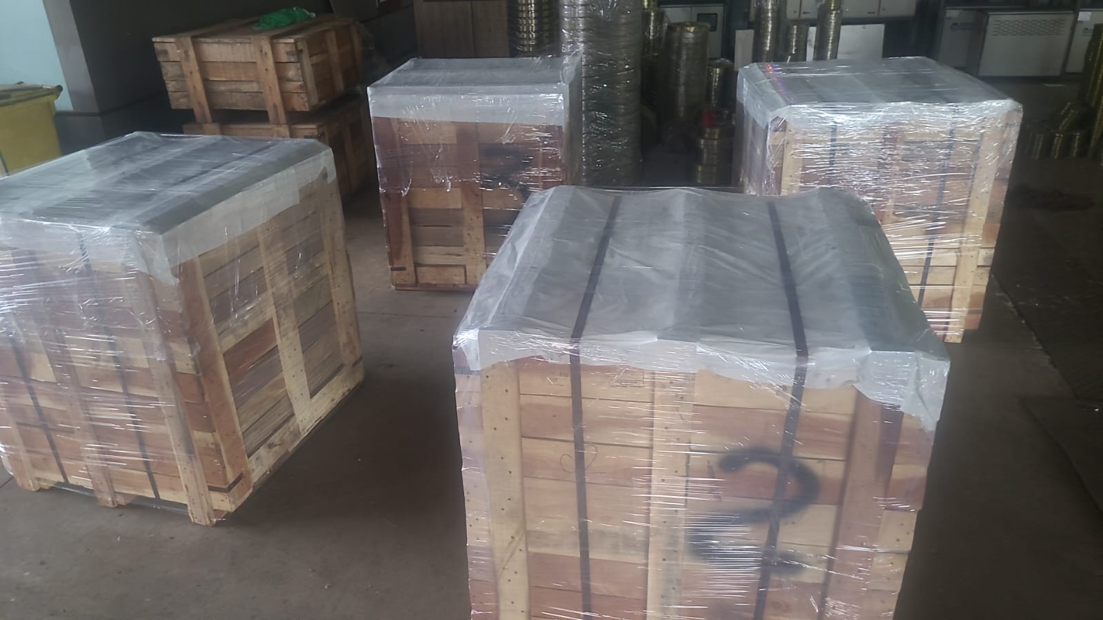 Multiple wrapped timber crates prepared on the workshop floor